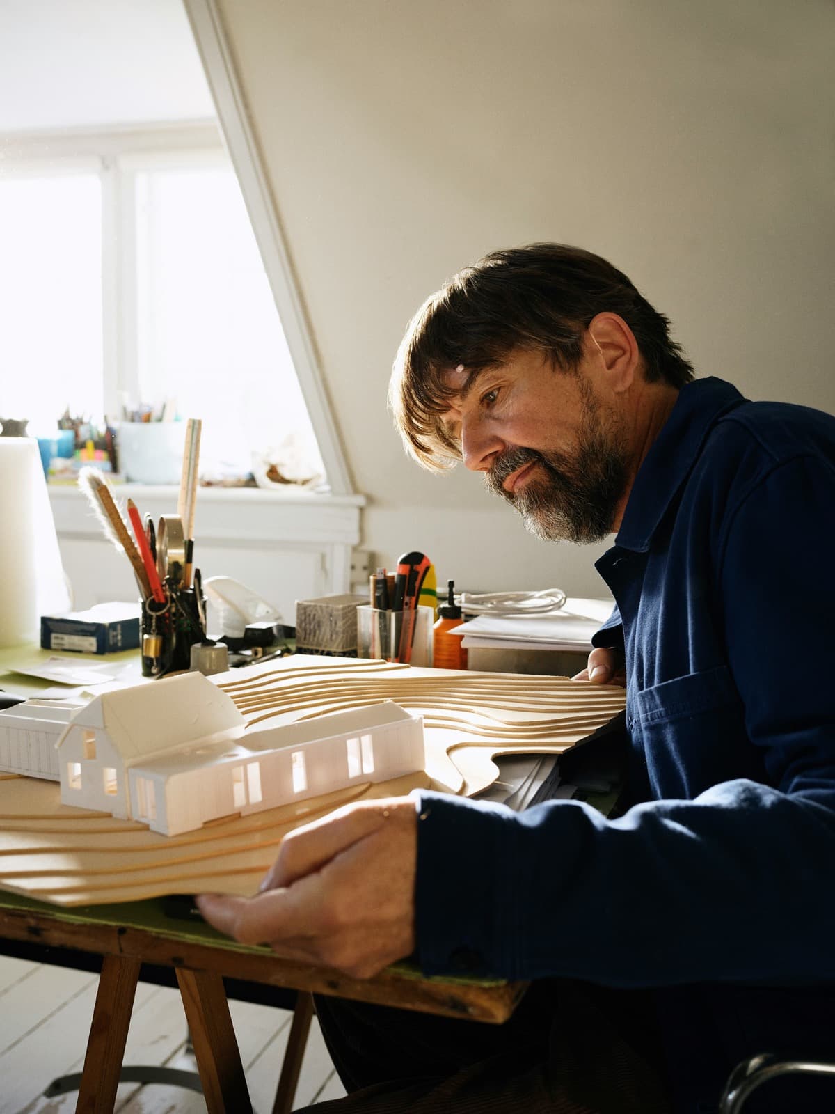 Architect working on a physical building model during project development